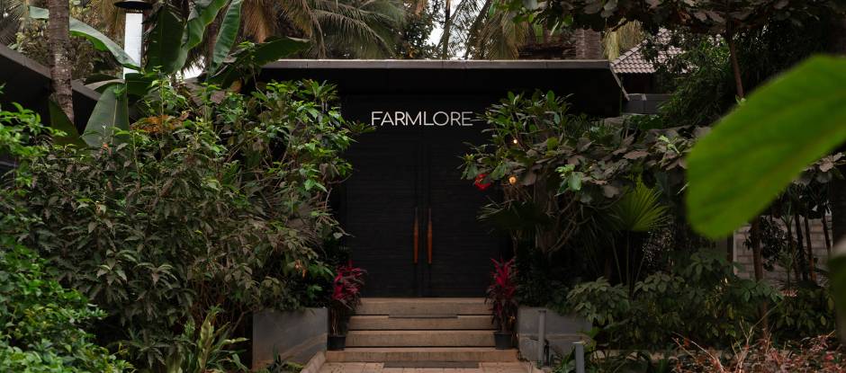 Farmlore restaurant entrance surrounded by tropical greenery