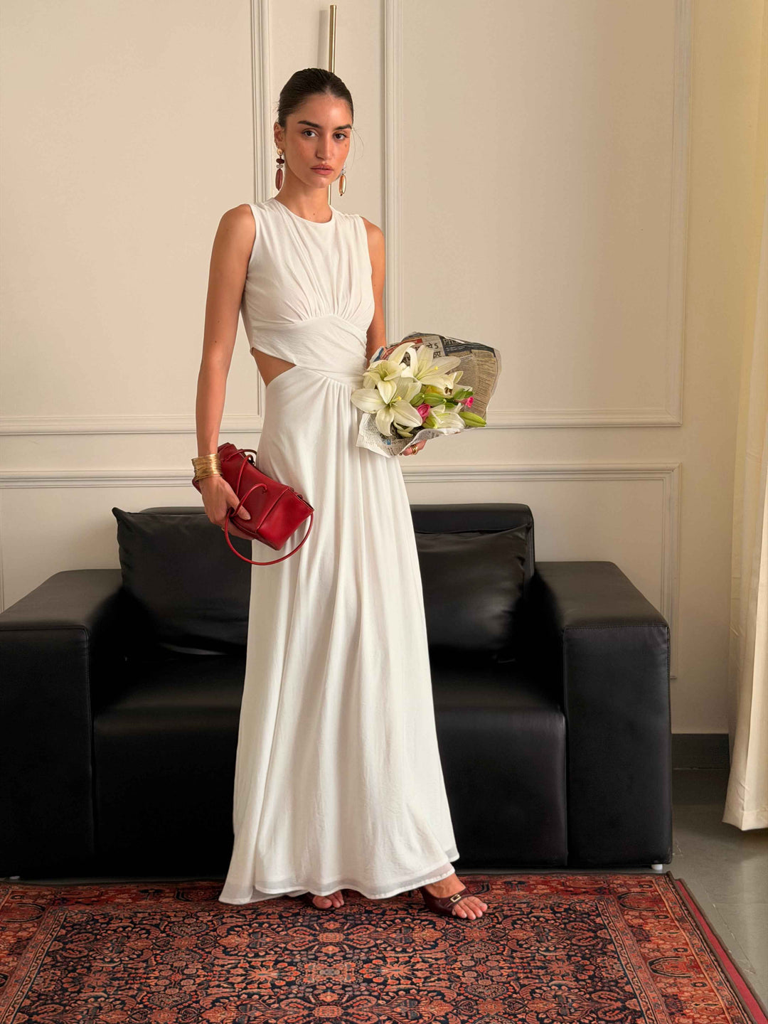 Model wearing Evierose’s white Coast maxi dress with waist cut-outs