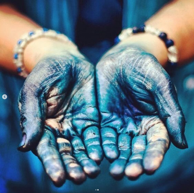 Close-up of palms stained blue by dye
