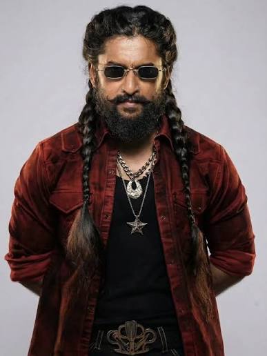 Nani wearing sunglasses and a dark red jacket