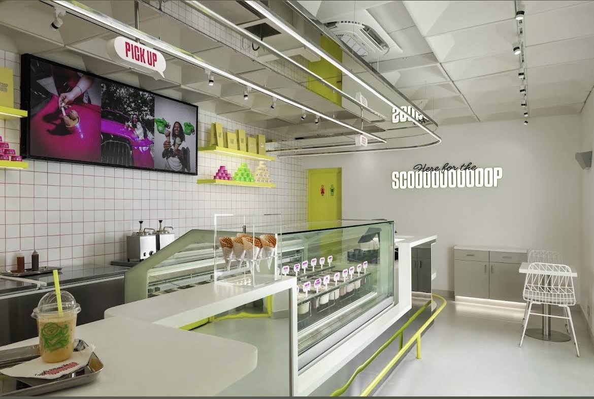 Scoop Room Indiranagar interior with a curved counter, ice cream display and colourful accents