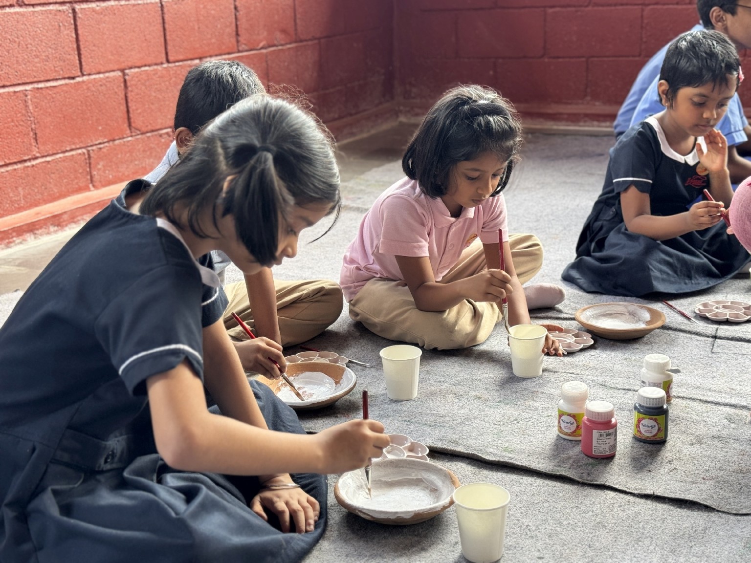 Children taking part in a craft painting workshop