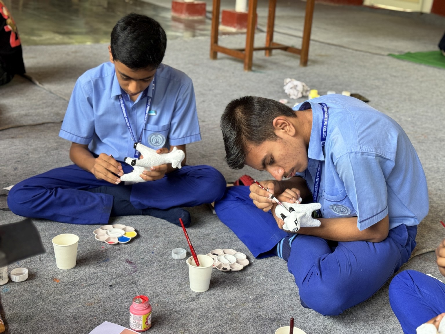 Students painting handmade craft objects