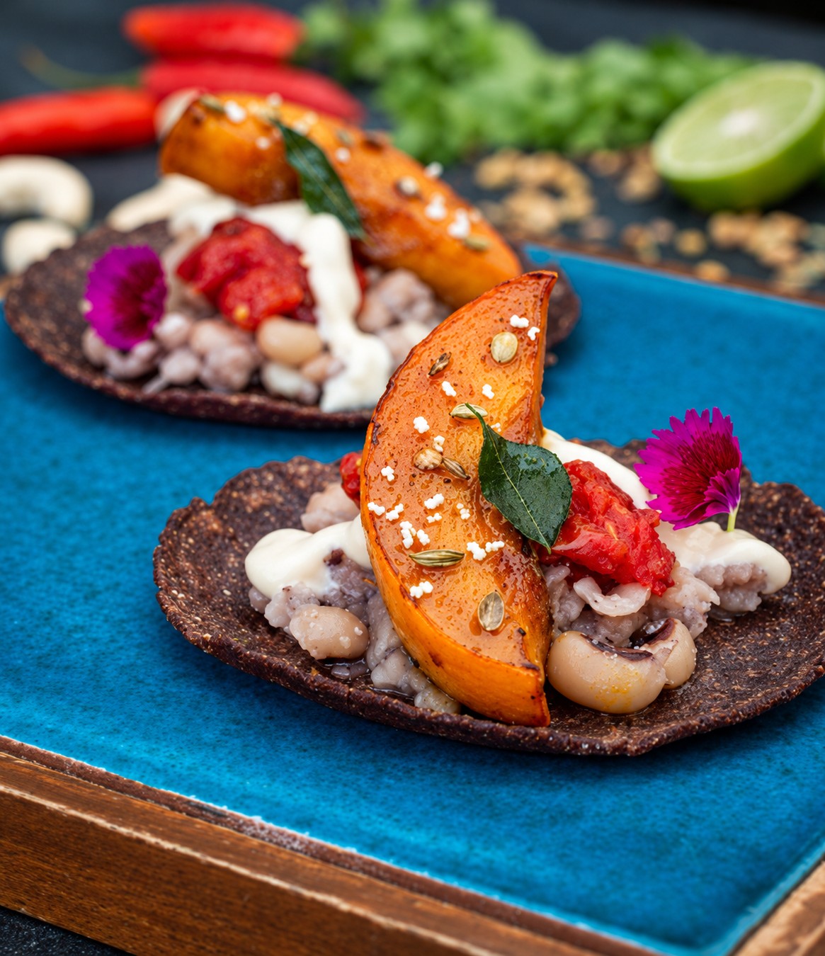 Ragi tacos topped with beans, roasted pumpkin and cashew sour cream