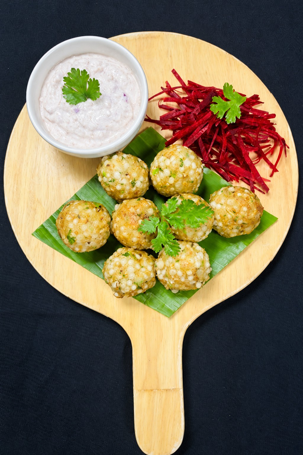 Golden sweet potato and sabudana appe on a banana leaf